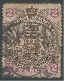 [Coat of Arms - End of Scroll Curled between Legs of Supporting Animals, տեսակ J2]